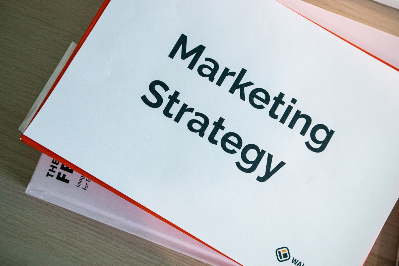 heros-img A marketing strategy document displayed on a desk, showcasing business planning essentials.
